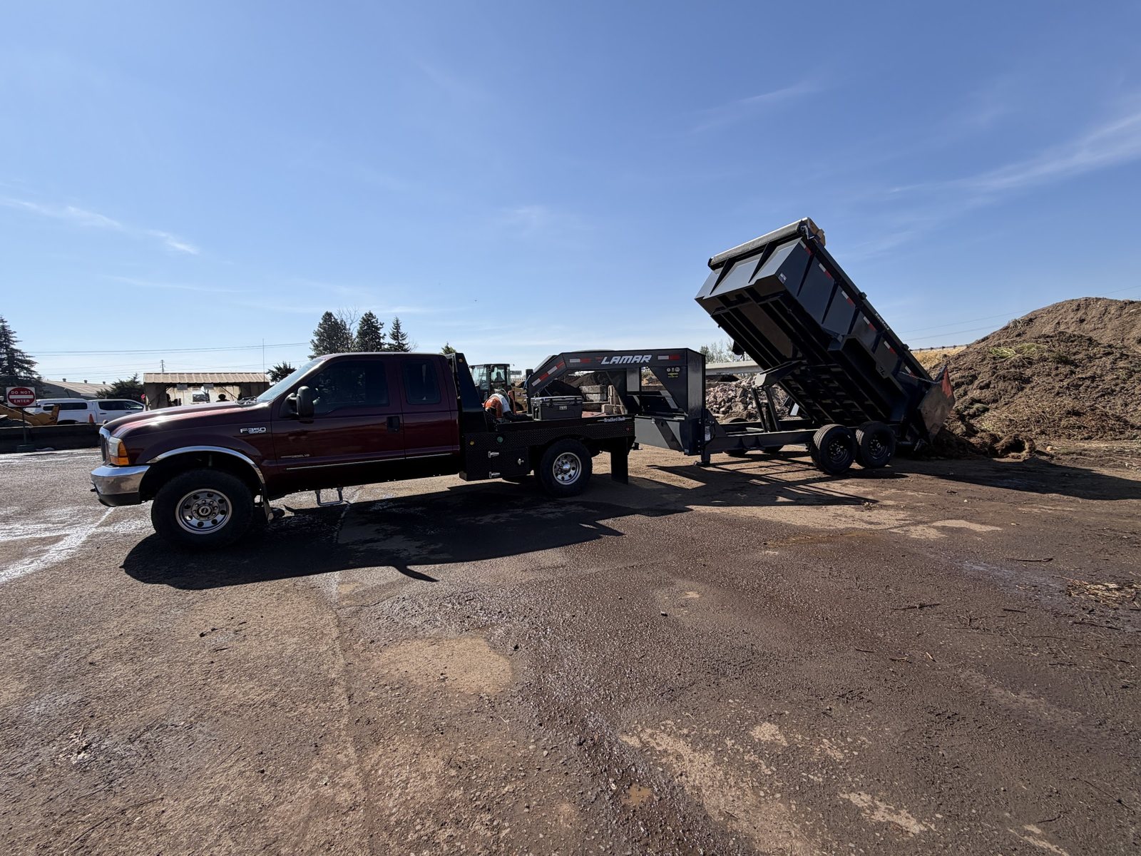 Vector Site and Land LLC truck and gooseneck dump trailer unloading material
