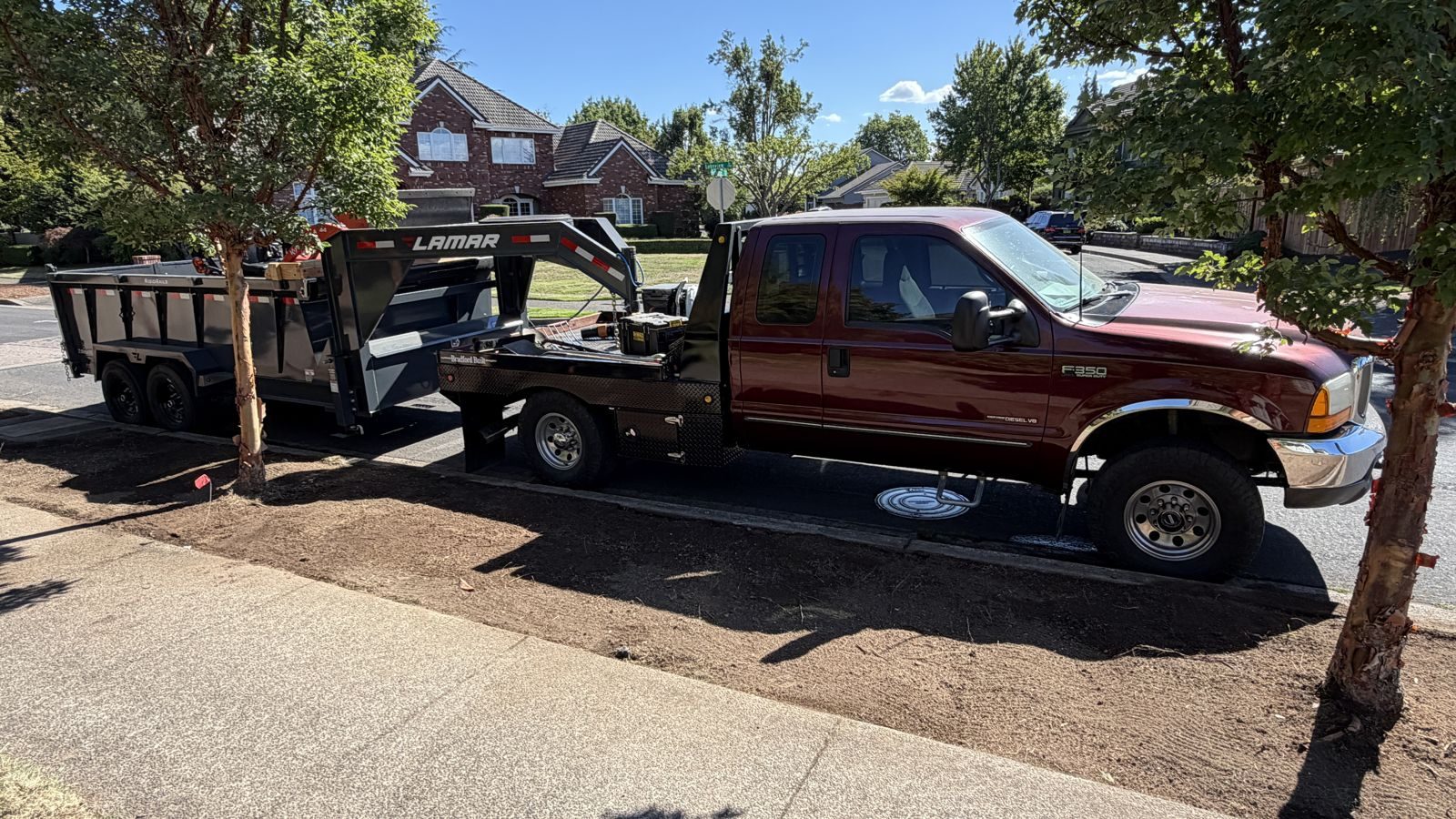 Vector Site and Land LLC work truck and gooseneck dump trailer on a job site
